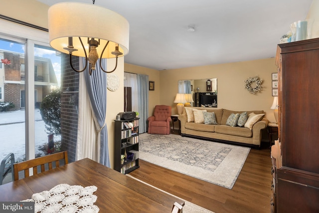 living room featuring dark hardwood / wood-style floors and an inviting chandelier