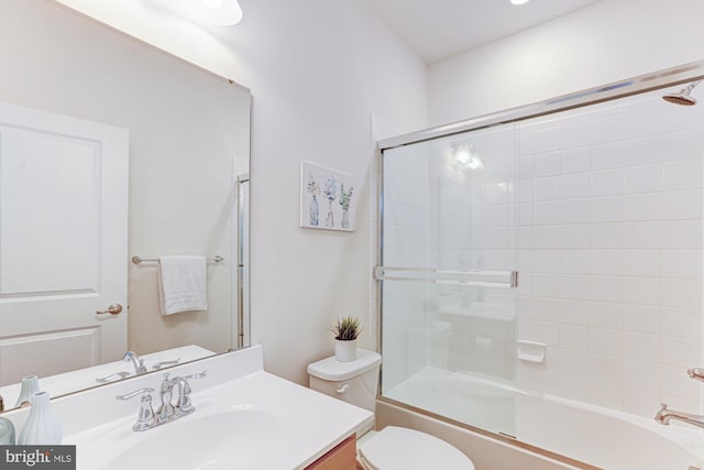 full bathroom with toilet, shower / bath combination with glass door, and vanity