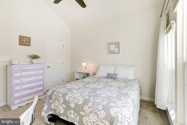 carpeted bedroom with ceiling fan and vaulted ceiling