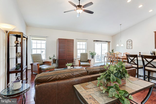 living room featuring ceiling fan, vaulted ceiling, a healthy amount of sunlight, and dark hardwood / wood-style floors