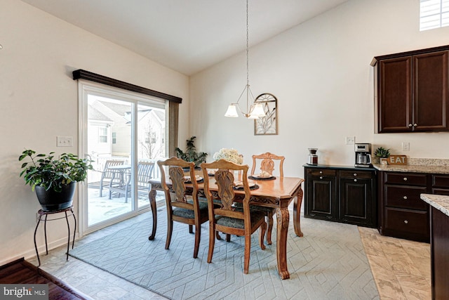 dining space with vaulted ceiling