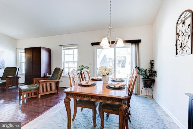 dining space featuring a notable chandelier and wood-type flooring