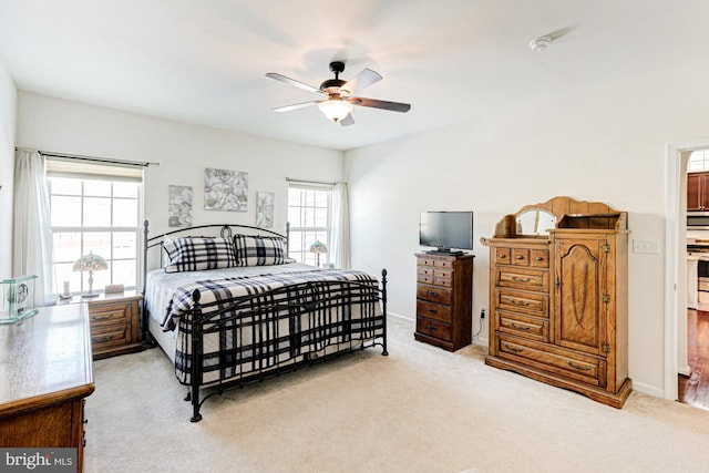 bedroom with light colored carpet and ceiling fan