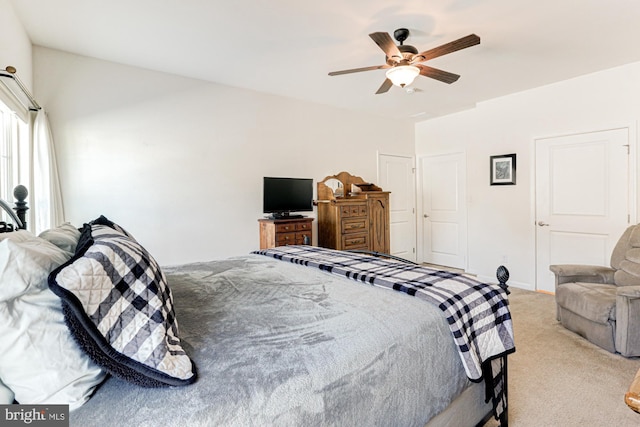 carpeted bedroom featuring a closet and ceiling fan