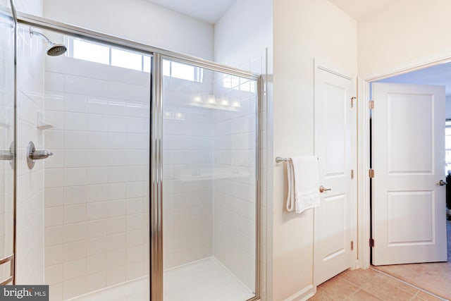 bathroom featuring tile patterned flooring and a shower with shower door