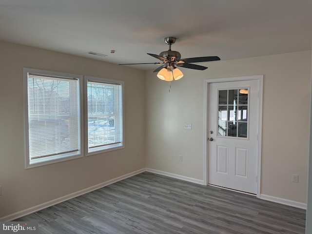 unfurnished room with hardwood / wood-style flooring and ceiling fan