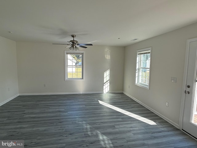 spare room with ceiling fan and dark hardwood / wood-style floors