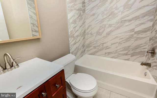 full bathroom featuring toilet, tile patterned floors, tiled shower / bath, and vanity