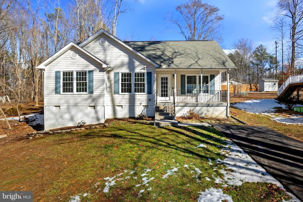 view of front of property with a front yard and a porch