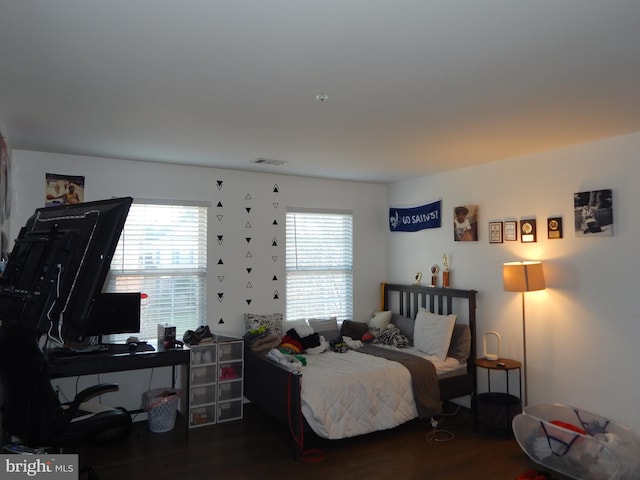 bedroom with dark hardwood / wood-style floors