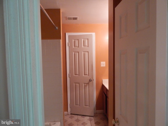 bathroom with vanity and a shower