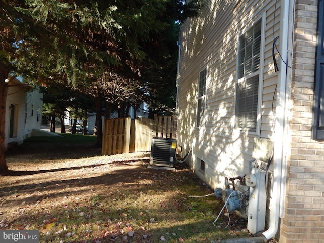 view of side of home featuring central AC unit