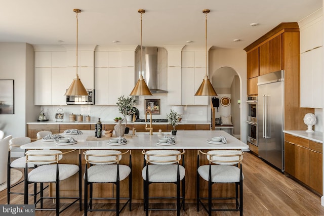 kitchen with decorative light fixtures, white cabinets, and appliances with stainless steel finishes