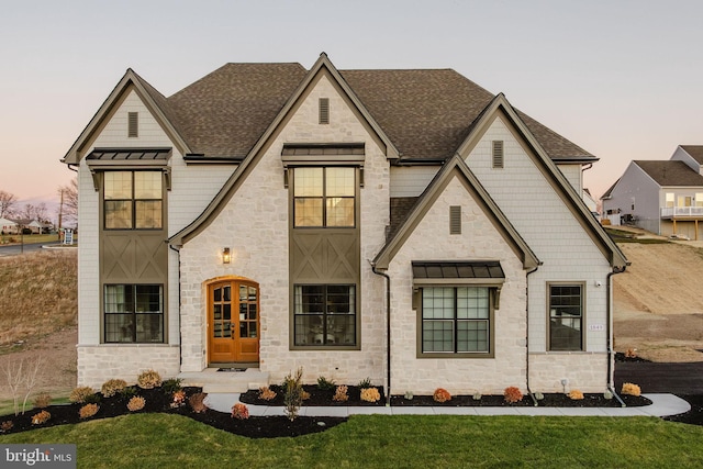 view of front facade with french doors and a yard