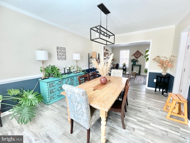 dining space with crown molding and wood-type flooring