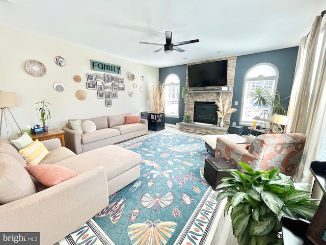 living room with ceiling fan, hardwood / wood-style floors, and a fireplace