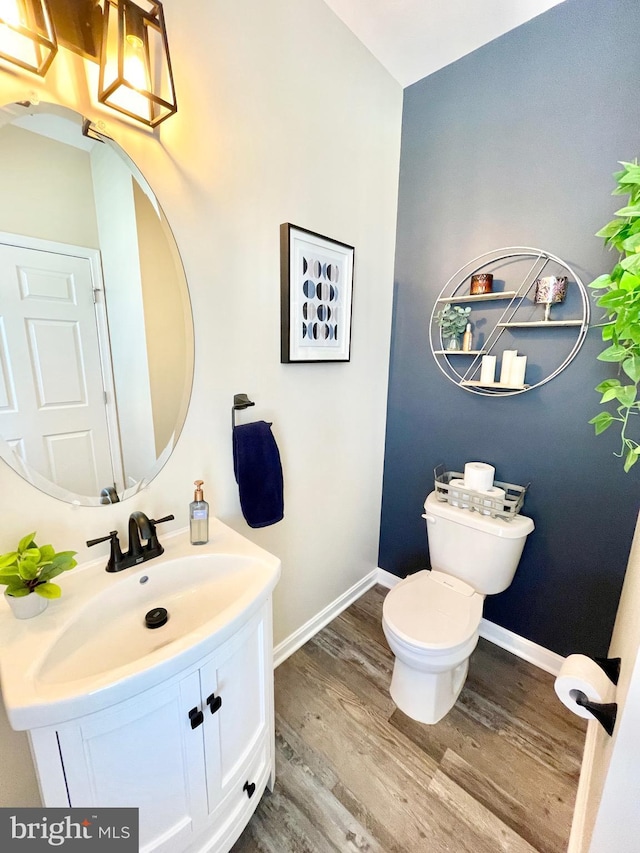 bathroom featuring vanity, hardwood / wood-style floors, and toilet