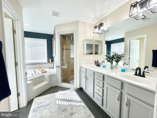 bathroom featuring shower with separate bathtub and vanity