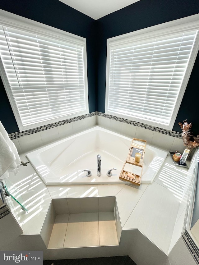 bathroom featuring tiled bath