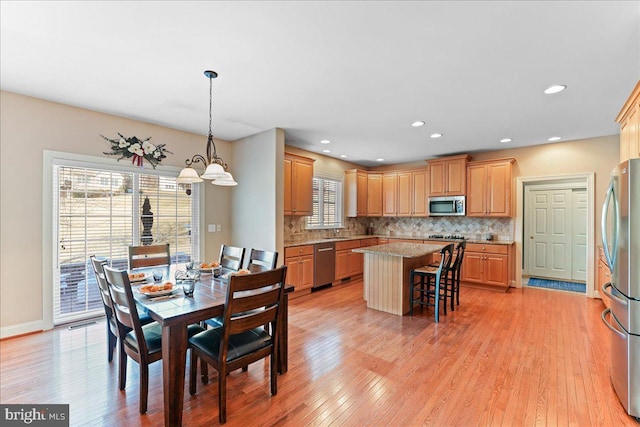 dining area with light hardwood / wood-style flooring and sink