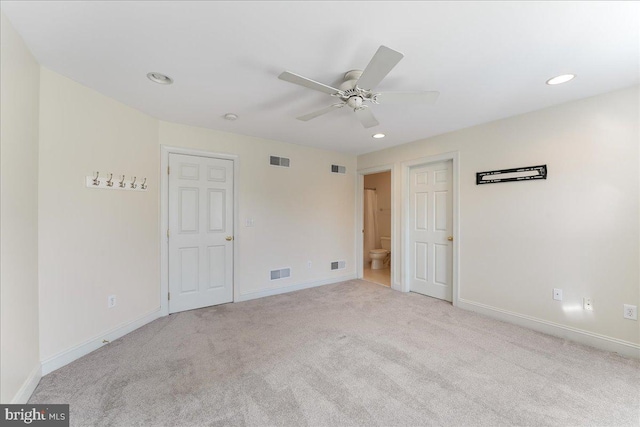 carpeted spare room featuring ceiling fan