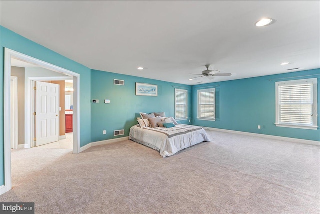 unfurnished bedroom featuring ceiling fan and light colored carpet