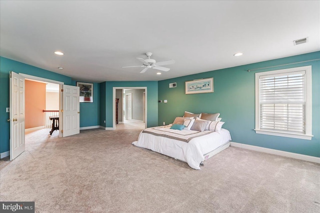 bedroom featuring ceiling fan and light carpet