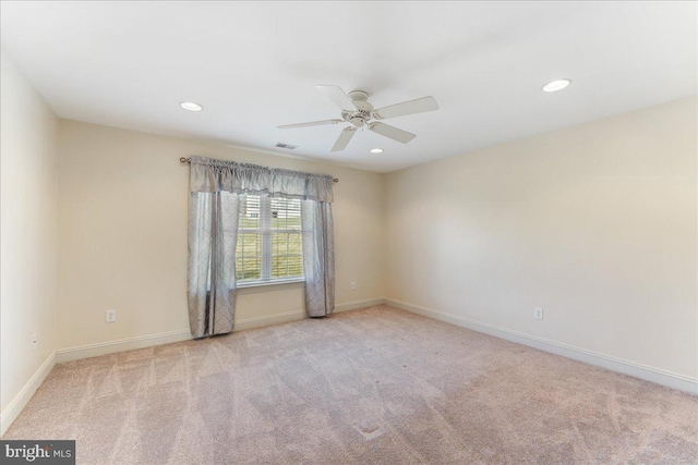 unfurnished room featuring ceiling fan and light colored carpet