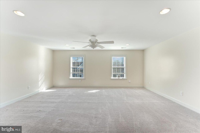 carpeted spare room with ceiling fan