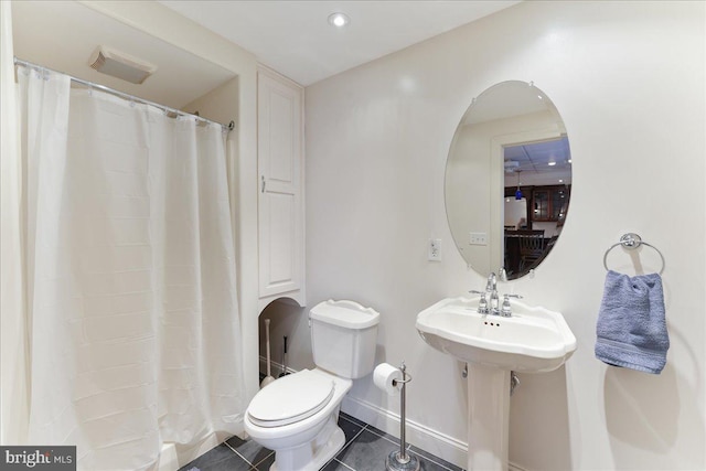 bathroom with sink, tile patterned floors, and toilet