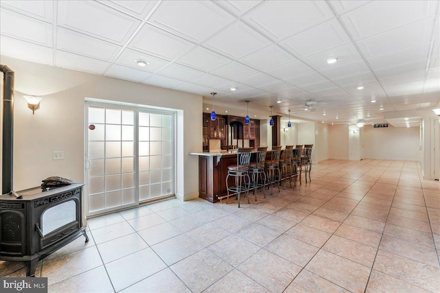 kitchen with a kitchen breakfast bar and a wood stove