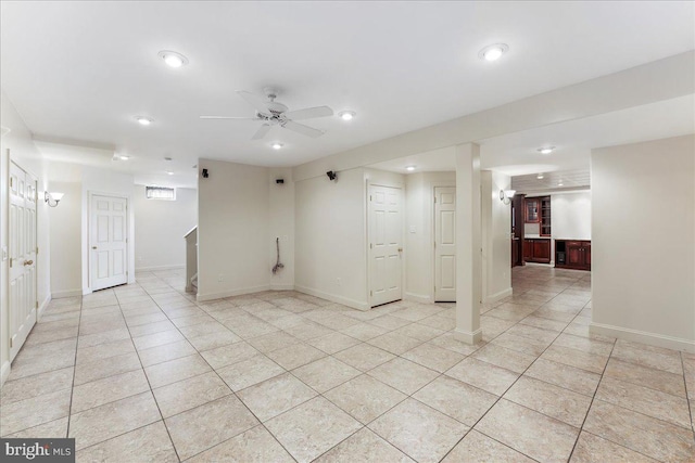 tiled empty room featuring ceiling fan with notable chandelier