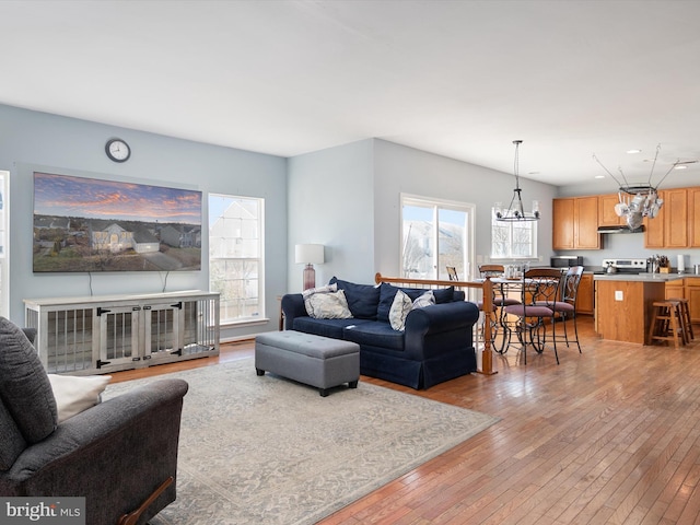 living room featuring a notable chandelier and light hardwood / wood-style flooring