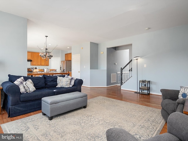 living room with hardwood / wood-style floors and a chandelier