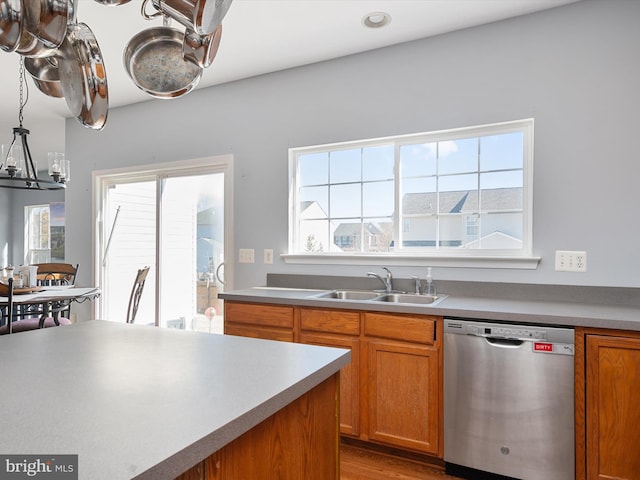 kitchen featuring hardwood / wood-style flooring, dishwasher, and sink