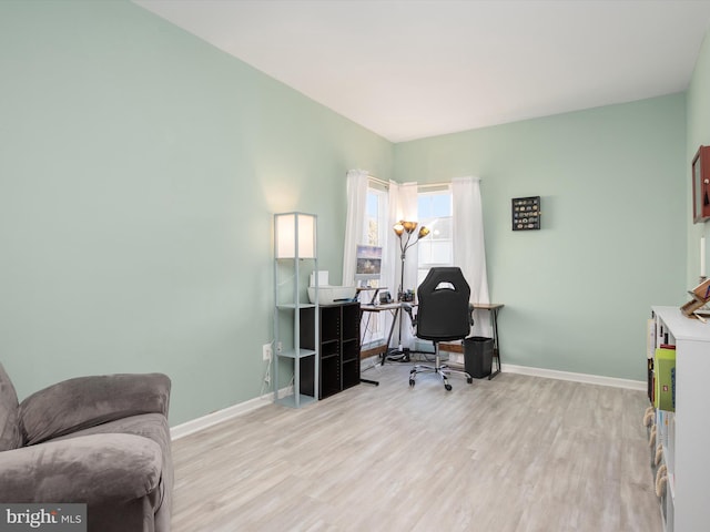 home office with light hardwood / wood-style floors