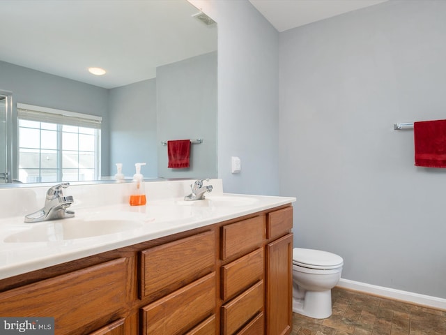 bathroom with vanity and toilet