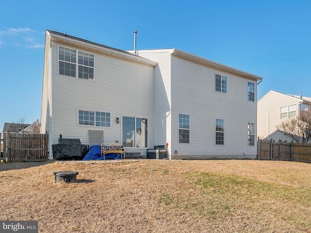 back of house with a lawn