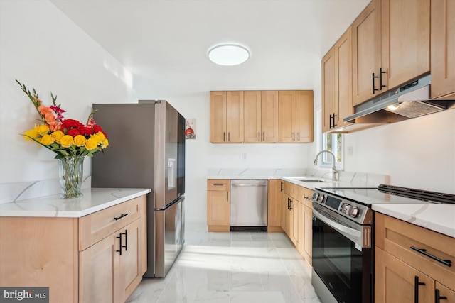 kitchen featuring light stone countertops, sink, light brown cabinets, and stainless steel appliances