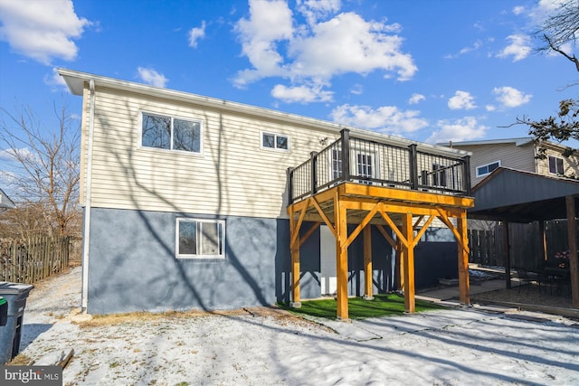 rear view of house featuring a wooden deck