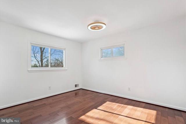 unfurnished room featuring dark hardwood / wood-style flooring