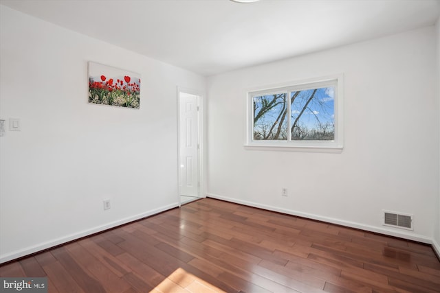 unfurnished room with dark hardwood / wood-style floors