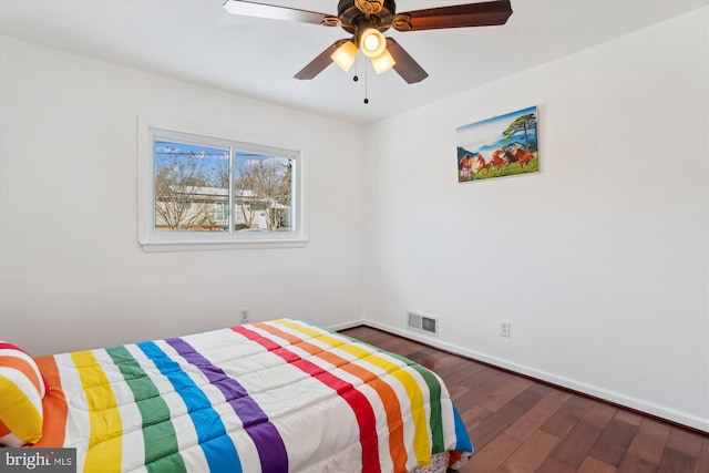 bedroom with ceiling fan and dark hardwood / wood-style floors