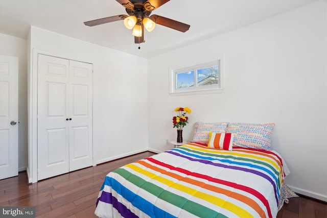 bedroom with a closet, dark hardwood / wood-style flooring, and ceiling fan