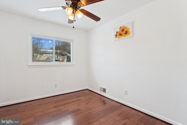 empty room with ceiling fan and dark hardwood / wood-style floors