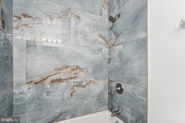 interior details featuring tiled shower / bath