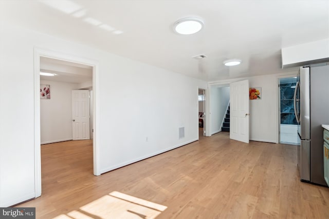 spare room featuring light wood-type flooring