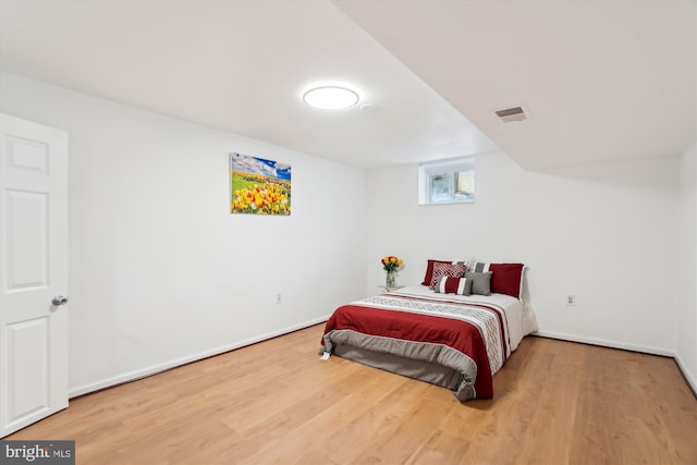 bedroom with hardwood / wood-style floors