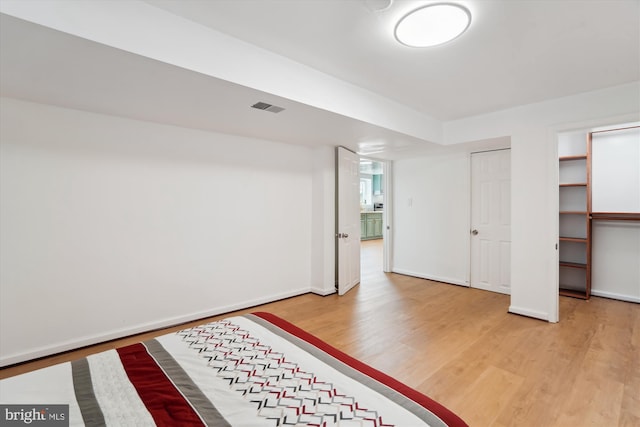 basement with hardwood / wood-style flooring