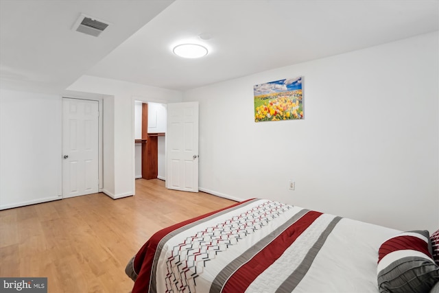 bedroom with wood-type flooring